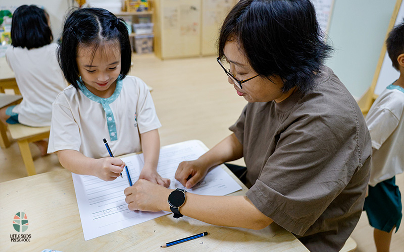 Preschool With Teacher Guiding Children
