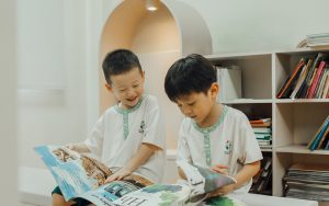Little Seeds preschoolers reading a picture book together indoors.