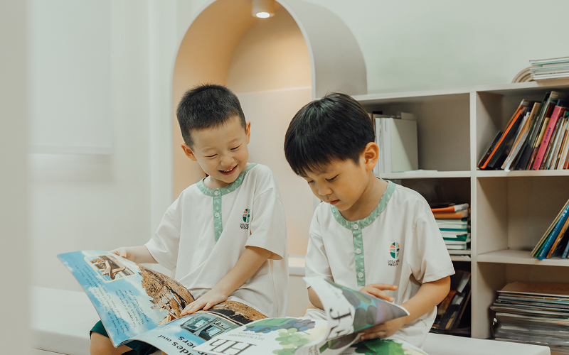 Little Seeds preschoolers reading a picture book together indoors.