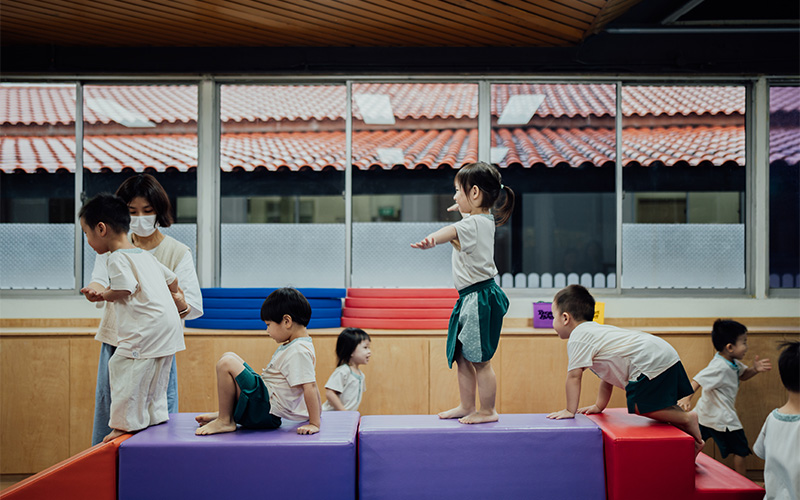 Happy preschool children balancing on an obstacle course