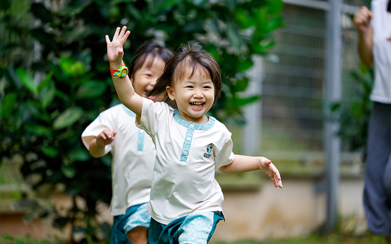 Happy preschoolers running and playing outdoors