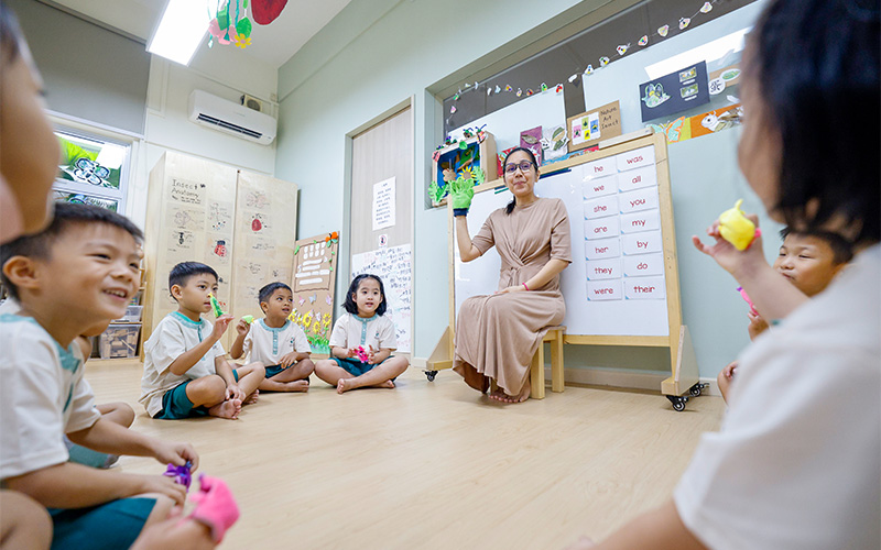Little Seeds teacher guiding daily interactions during circle time.