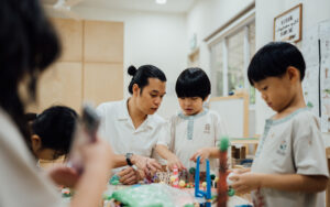 Little Seeds teacher guiding students during a hands-on activity.