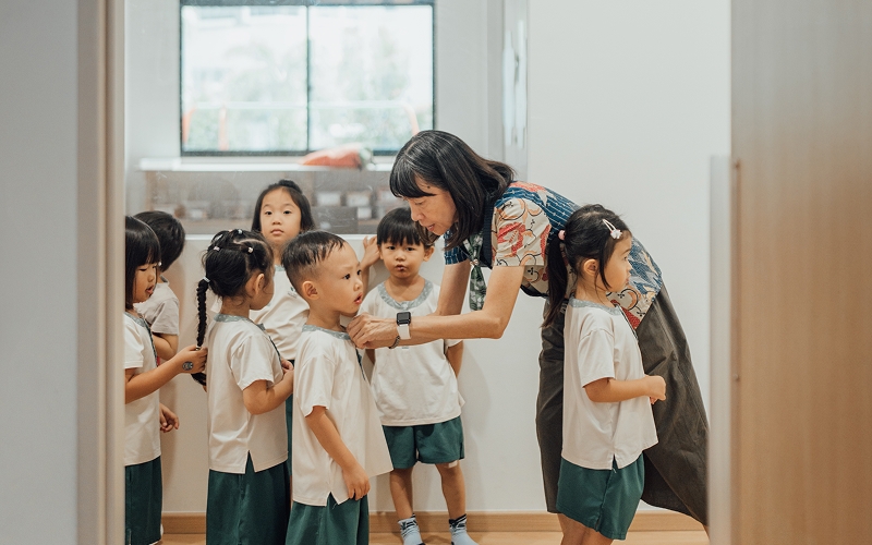 Little Seeds teacher providing personalized care to a young student.