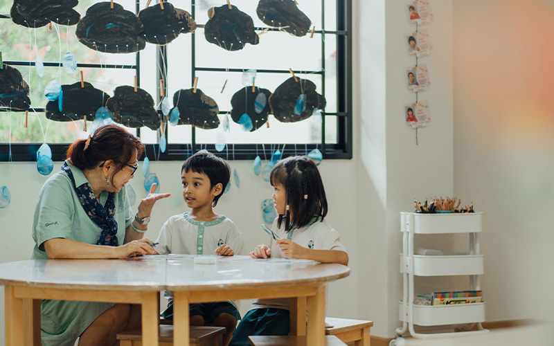 Little Seeds educator guiding young children during a lesson.
