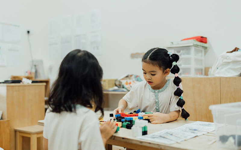 Preschoolers developing problem-solving skills by building with blocks.