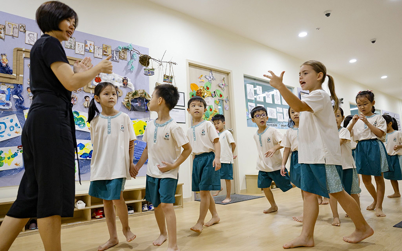 Students and teacher engaged in classroom activities at Little Seeds.